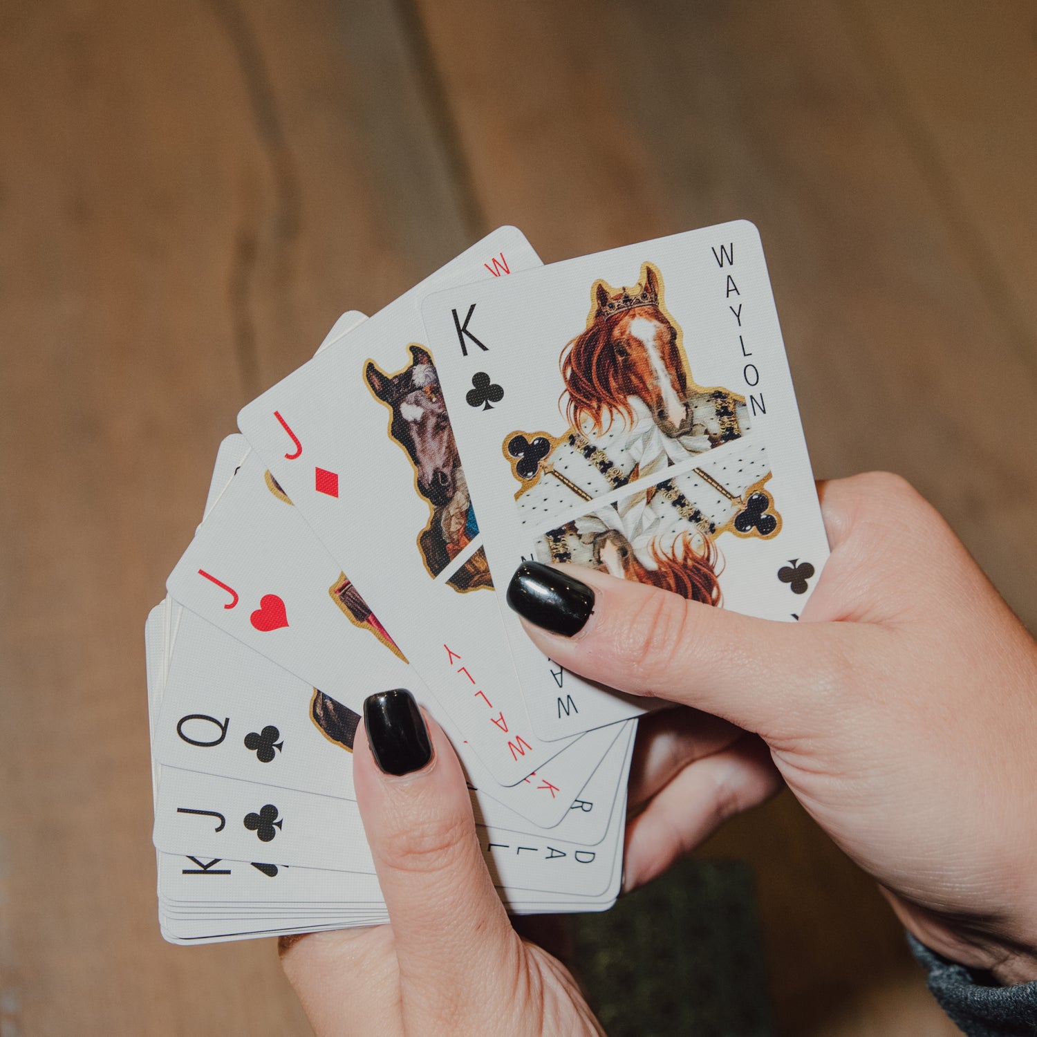 woman's hands holding a few cards