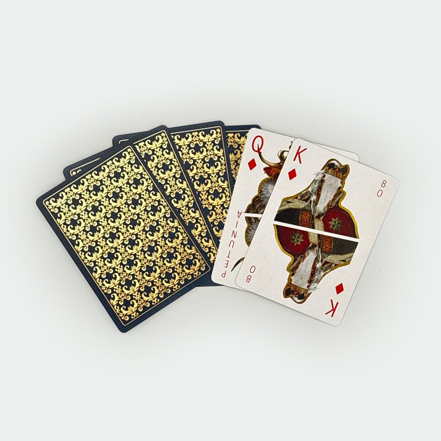 Playing cards with decorative backs and a King of Diamonds card on a white background