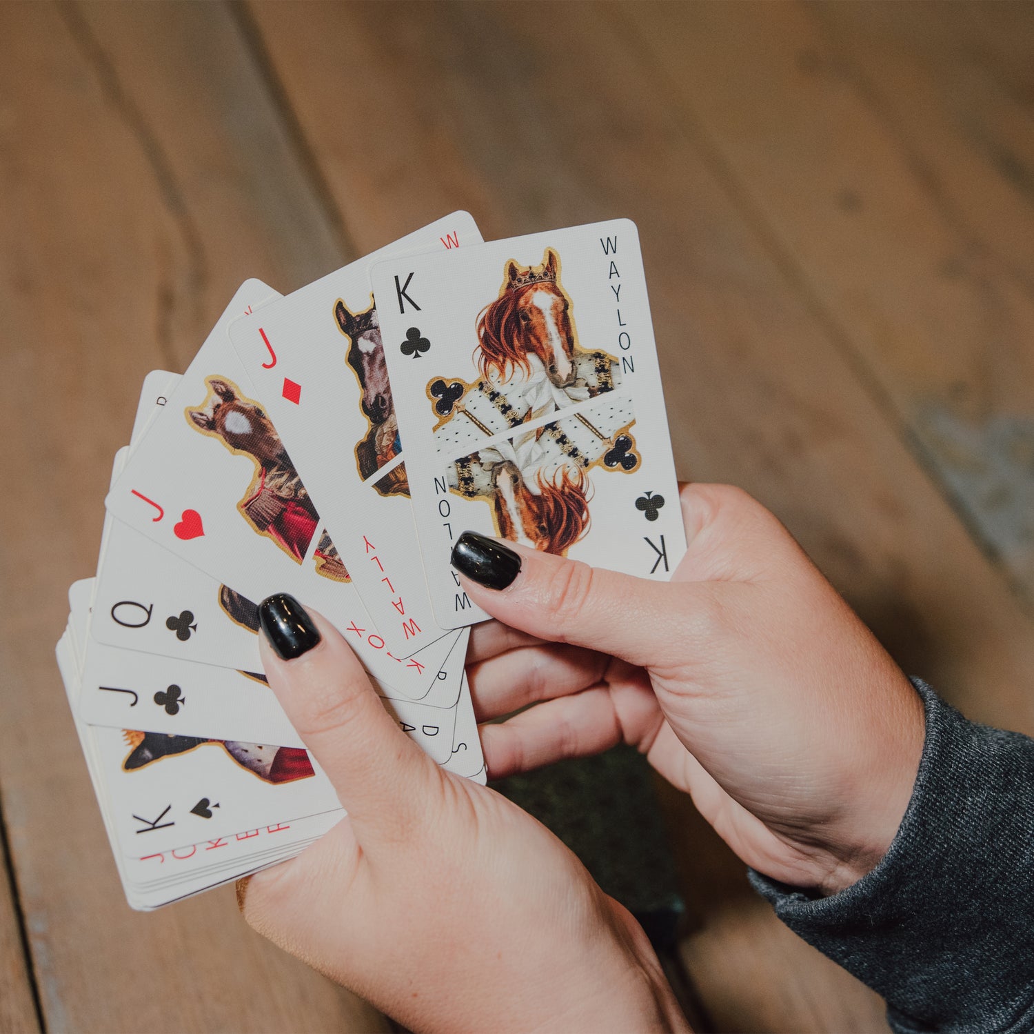woman's hand holding cards
